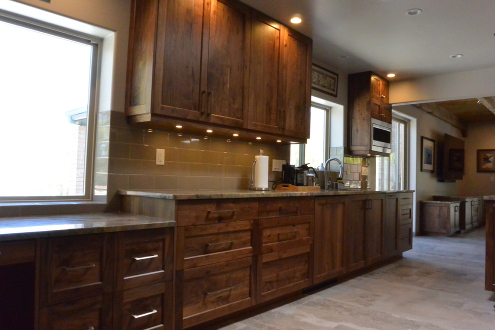 Huge transitional l-shaped porcelain tile and gray floor open concept kitchen photo with an undermount sink, shaker cabinets, medium tone wood cabinets, quartzite countertops, white backsplash, porcelain backsplash, paneled appliances, an island and green countertops