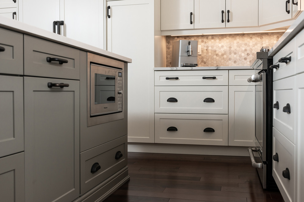 Home design - transitional dark wood floor and brown floor home design idea with white cabinets, quartz countertops, paneled appliances, an island and white countertops