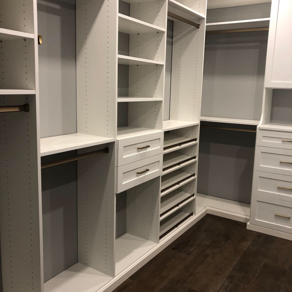 Large traditional gender-neutral walk-in wardrobe in Toronto with recessed-panel cabinets, white cabinets, dark hardwood floors and brown floor.