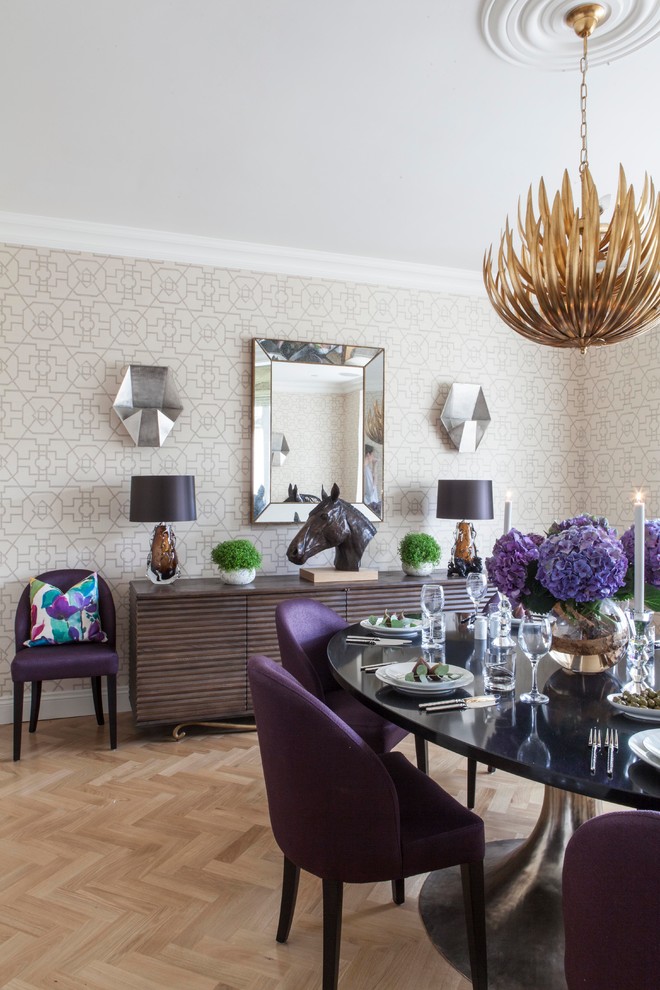 Inspiration for a transitional dining room in London with grey walls and light hardwood floors.