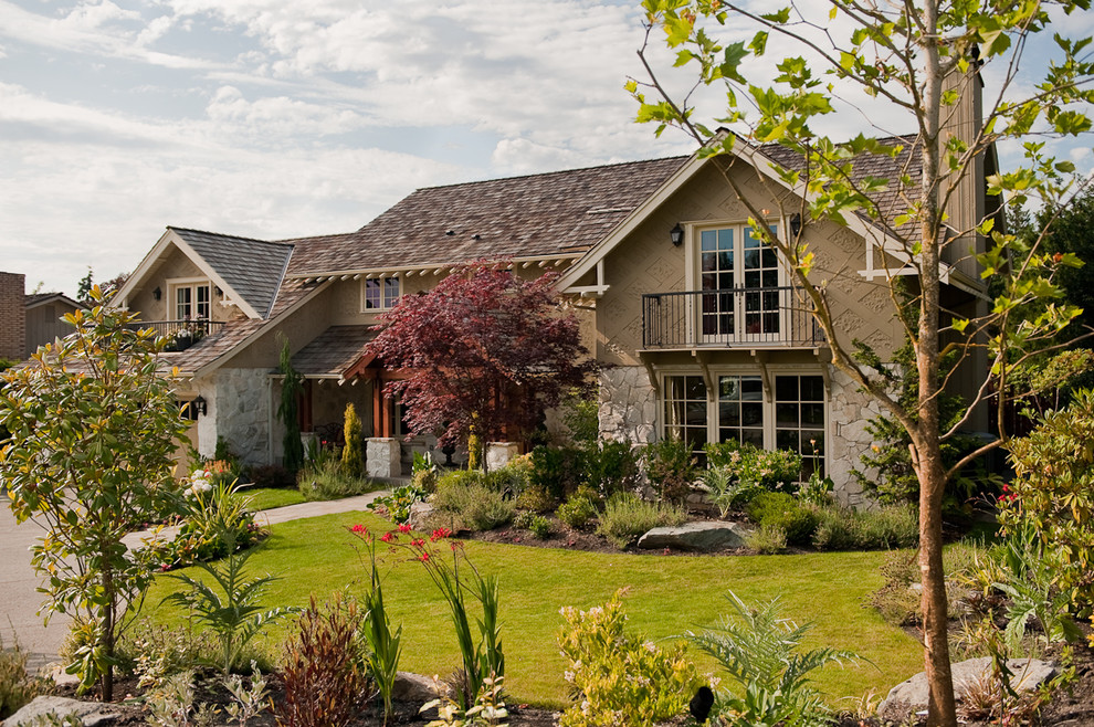 Large traditional two-storey beige exterior in Seattle with stone veneer.
