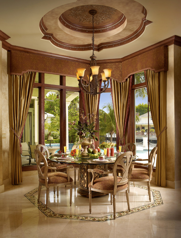 This is an example of a mid-sized mediterranean open plan dining in Miami with beige walls, marble floors, beige floor and no fireplace.