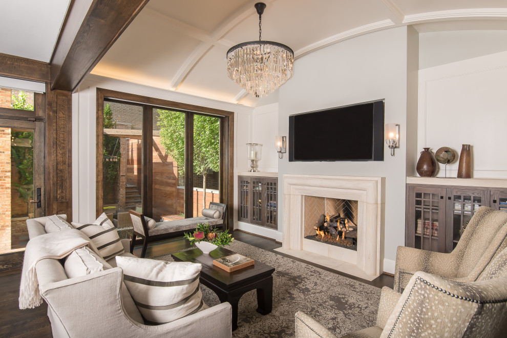 This is an example of a large traditional living room in Chicago with dark hardwood flooring, a standard fireplace, a wall mounted tv, brown floors and a coffered ceiling.