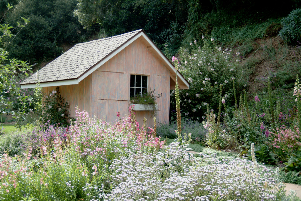 Inspiration for a farmhouse partial sun backyard stone flower bed in Santa Barbara.