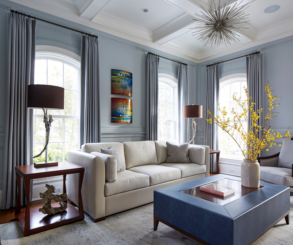 Transitional formal living room in New York with blue walls.