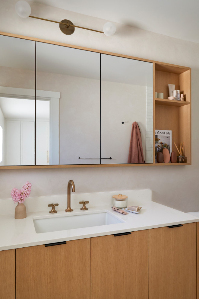 Inspiration for a small scandinavian master bathroom in San Francisco with flat-panel cabinets, brown cabinets, a curbless shower, white tile, ceramic tile, pink walls, terrazzo floors, an undermount sink, engineered quartz benchtops, pink floor, an open shower, white benchtops, a niche, a single vanity and a floating vanity.