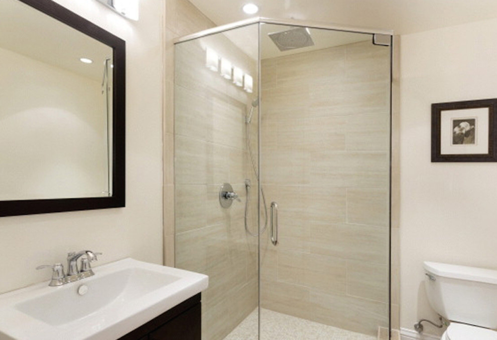 This is an example of a small contemporary 3/4 bathroom in San Francisco with an undermount sink, dark wood cabinets, a corner shower, a one-piece toilet, beige tile, stone tile, beige walls, engineered quartz benchtops, a hinged shower door and white benchtops.