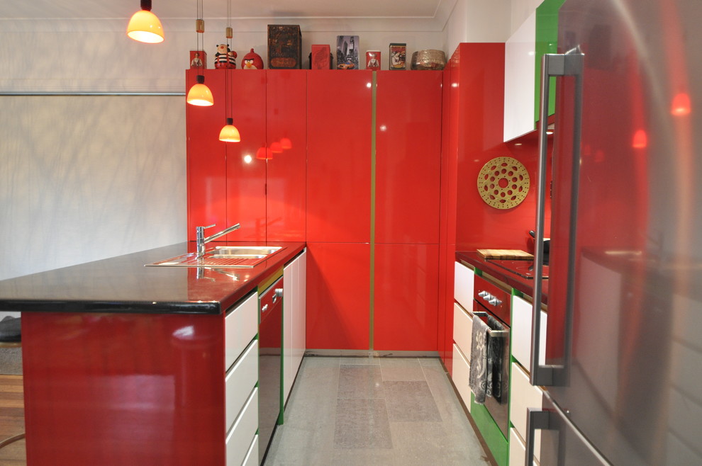 This is an example of a modern u-shaped eat-in kitchen in Hobart with a double-bowl sink, red cabinets, white splashback, subway tile splashback, stainless steel appliances and ceramic floors.