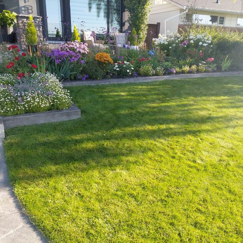 This is an example of a mid-sized contemporary full sun front yard garden path in Calgary for summer.