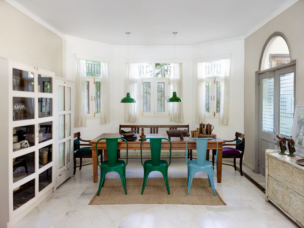Inspiration for a mid-sized eclectic dining room in Delhi with white walls and marble floors.