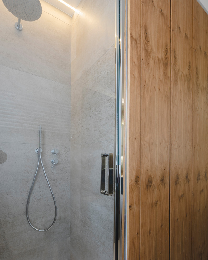 This is an example of a large industrial shower room bathroom in Milan with flat-panel cabinets, distressed cabinets, a built-in bath, a corner shower, a two-piece toilet, grey tiles, porcelain tiles, white walls, porcelain flooring, a vessel sink, tiled worktops, grey floors, a hinged door, white worktops and a single sink.