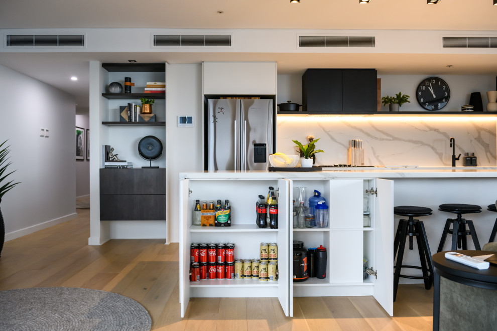Photo of a contemporary open plan kitchen in Melbourne with flat-panel cabinets and with island.