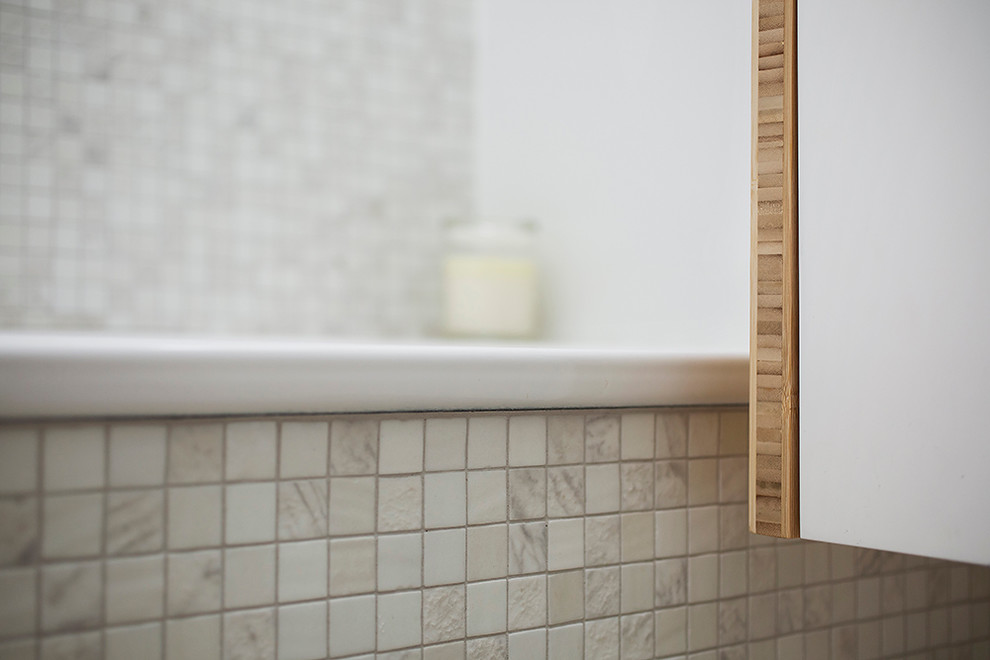 Mid-sized beach style master bathroom in Sydney with white cabinets, a drop-in tub, a corner shower, a wall-mount toilet, beige tile, mosaic tile, white walls, ceramic floors and wood benchtops.