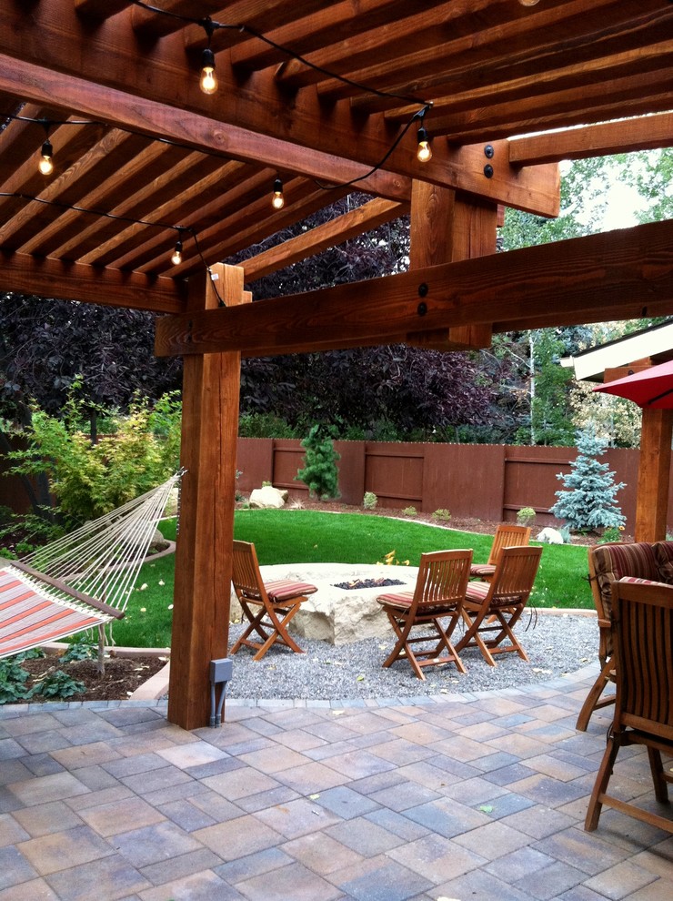 Mid-sized traditional backyard patio in Boise with concrete pavers and a pergola.