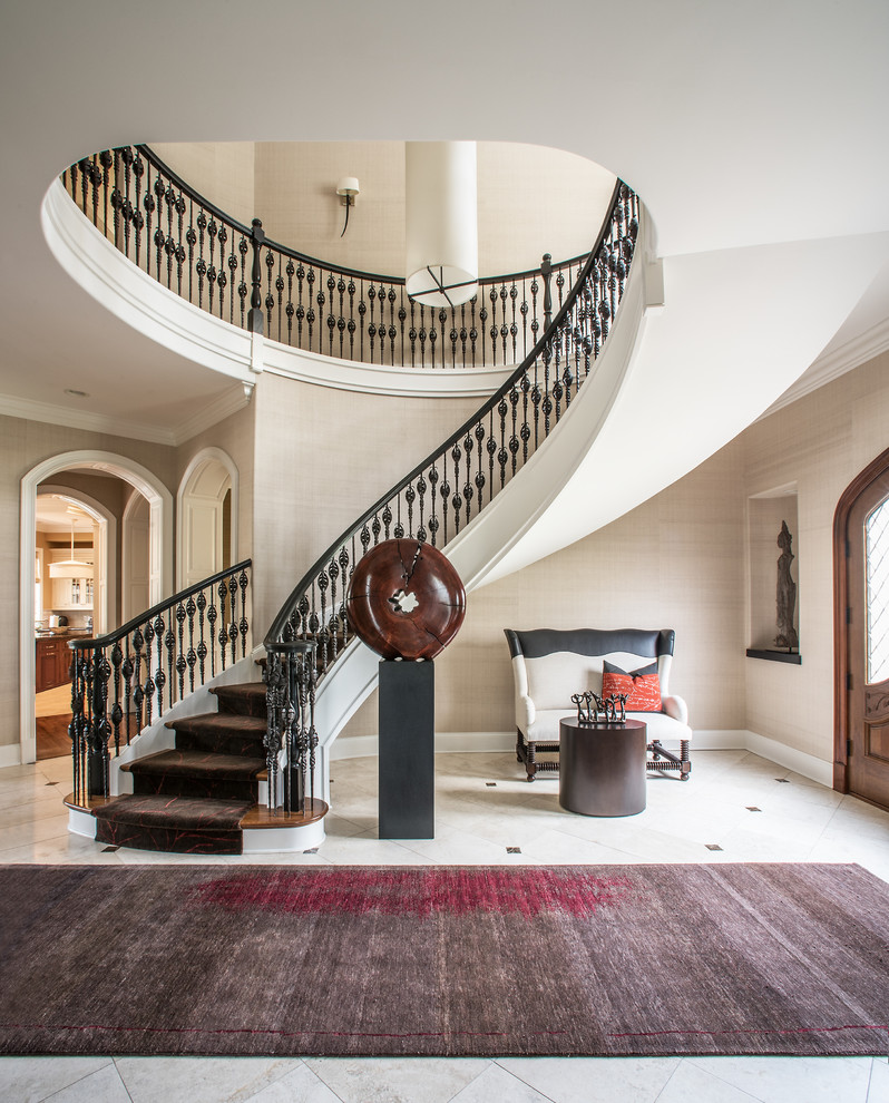 Photo of a large traditional carpeted curved staircase in Chicago with carpet risers.