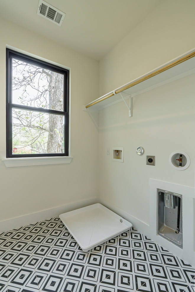 Transitional dedicated laundry room in Austin with white walls.