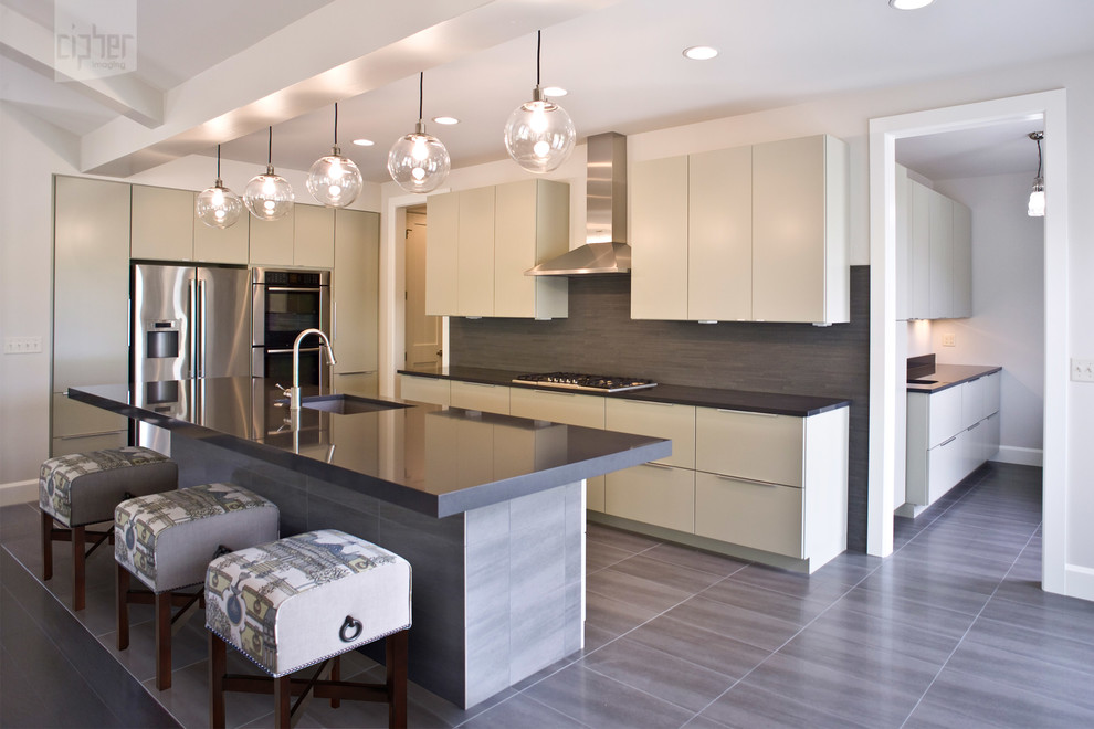 Inspiration for a mid-sized transitional l-shaped porcelain tile and gray floor kitchen pantry remodel with an undermount sink, flat-panel cabinets, gray cabinets, gray backsplash, stainless steel appliances, gray walls, an island, quartz countertops and ceramic backsplash