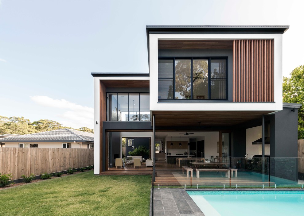 Design ideas for a contemporary two-storey multi-coloured house exterior in Brisbane with mixed siding and a flat roof.