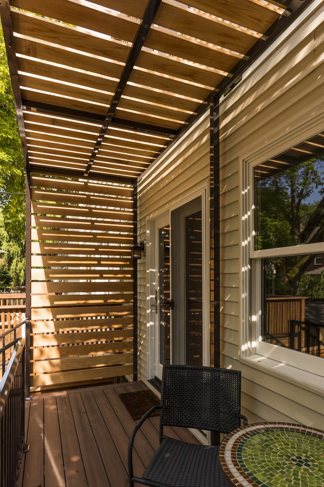 Inspiration for a small transitional backyard deck in DC Metro with a pergola.