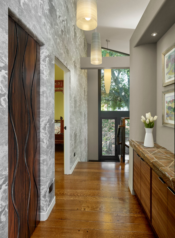 Mid-sized trendy medium tone wood floor hallway photo in San Francisco with white walls