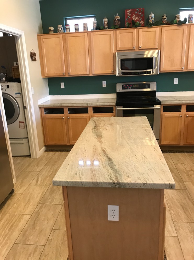 Eat-in kitchen - mid-sized transitional u-shaped porcelain tile and beige floor eat-in kitchen idea in Phoenix with recessed-panel cabinets, brown cabinets, granite countertops, green backsplash, stainless steel appliances, an island, gray countertops and a drop-in sink