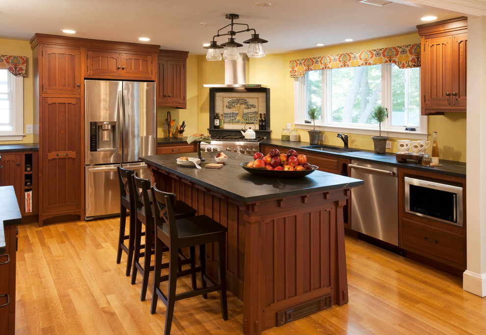 Inspiration for an arts and crafts u-shaped eat-in kitchen in Boston with dark wood cabinets and with island.