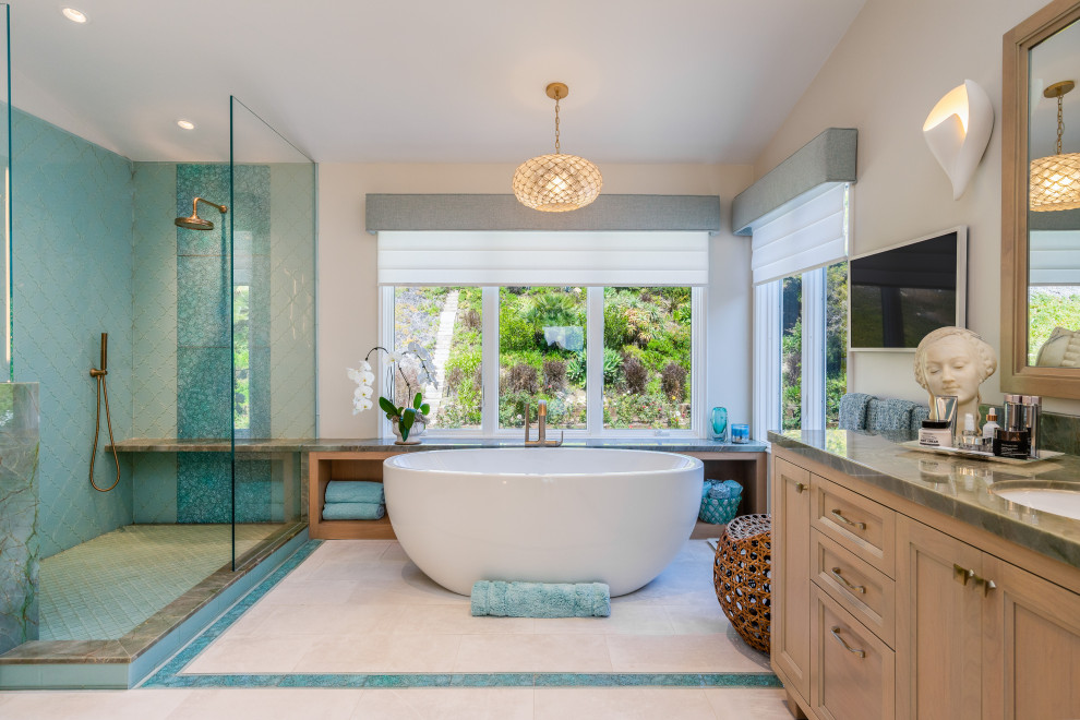 This is an example of a large beach style master bathroom in Los Angeles with recessed-panel cabinets, light wood cabinets, a freestanding tub, an open shower, a bidet, green tile, glass tile, porcelain floors, an undermount sink, quartzite benchtops, turquoise floor, an open shower, green benchtops, a shower seat, a double vanity, a built-in vanity and vaulted.