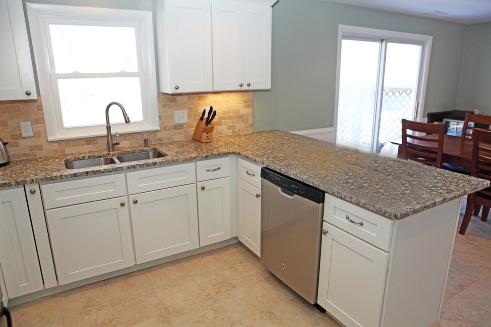 Mid-sized modern u-shaped eat-in kitchen in Providence with a double-bowl sink, shaker cabinets, white cabinets, granite benchtops, beige splashback, terra-cotta splashback, stainless steel appliances and ceramic floors.