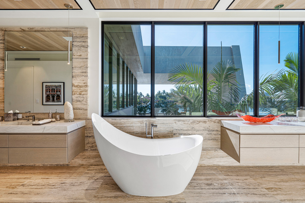 Photo of an expansive contemporary master bathroom in Miami with beige cabinets, a freestanding tub, an open shower, beige tile, marble, white walls, marble floors, an integrated sink, marble benchtops, beige floor, an open shower, white benchtops, a double vanity, a floating vanity and wood.