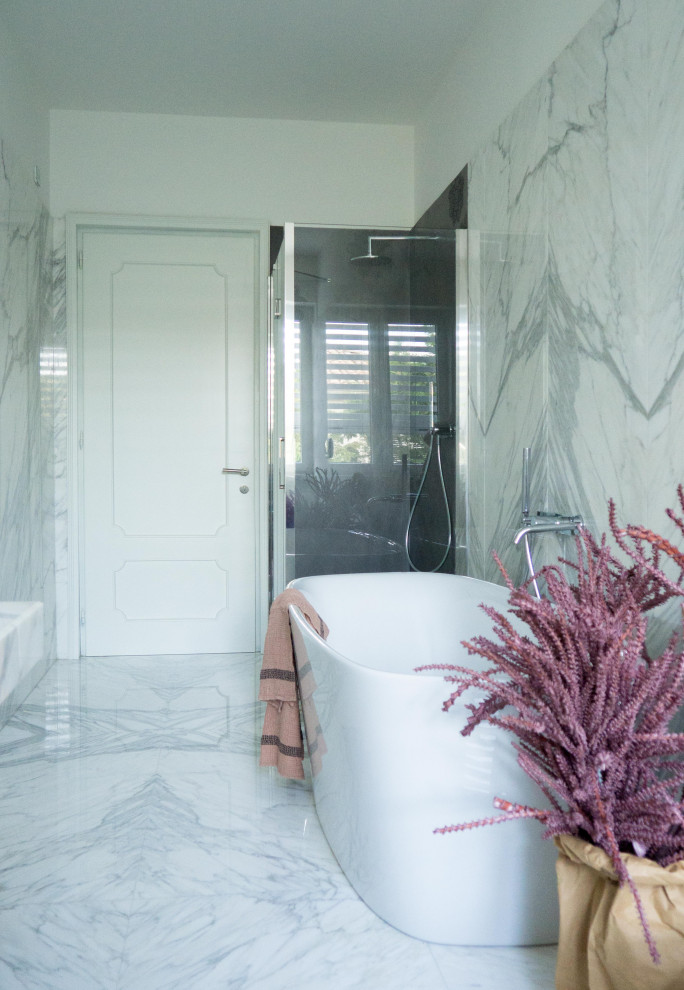 Example of a large trendy master marble tile single-sink bathroom design in Other with a two-piece toilet, a drop-in sink and a hinged shower door