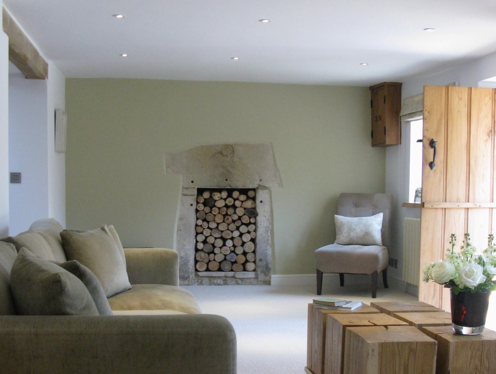 Photo of a mid-sized country open concept living room in Cheshire with a library, white walls, carpet, a two-sided fireplace, a stone fireplace surround and no tv.