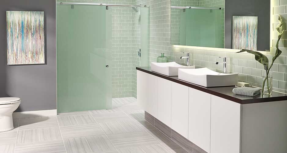 Inspiration for a mid-sized modern master bathroom in Orlando with flat-panel cabinets, white cabinets, a corner shower, a one-piece toilet, gray tile, glass tile, grey walls, porcelain floors, a vessel sink, solid surface benchtops, grey floor and a sliding shower screen.