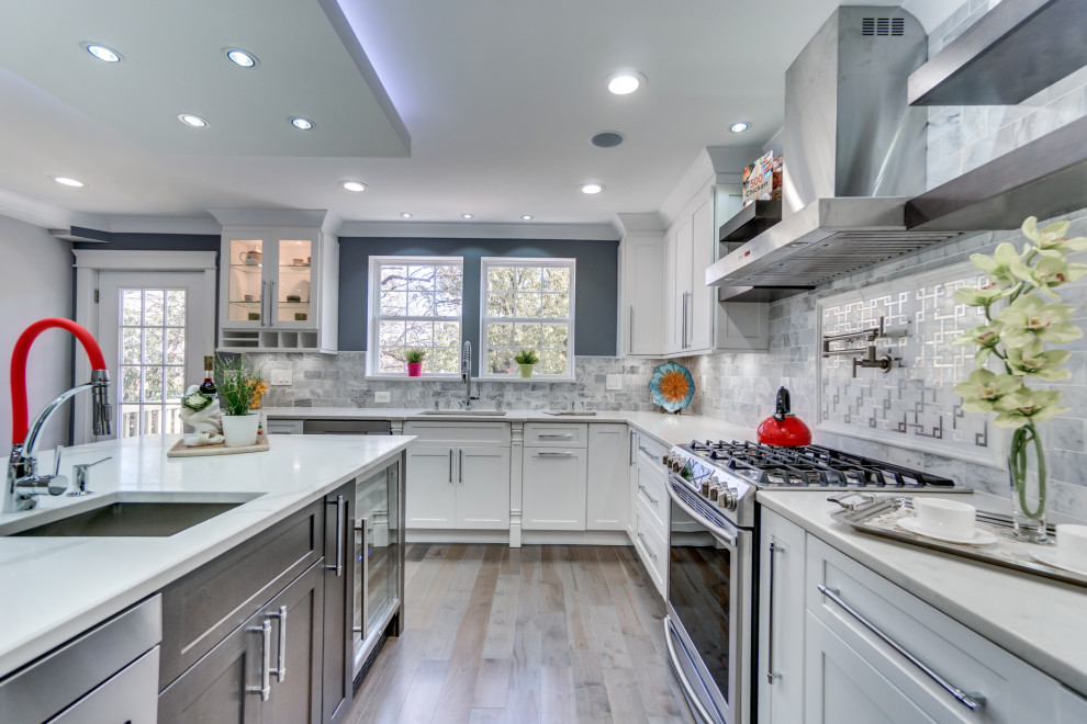 Large minimalist l-shaped plywood floor and gray floor eat-in kitchen photo in DC Metro with a drop-in sink, shaker cabinets, white cabinets, marble countertops, gray backsplash, mosaic tile backsplash, stainless steel appliances, an island and white countertops