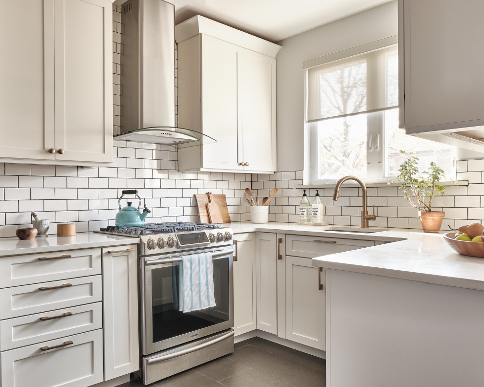Small modern u-shaped eat-in kitchen in New York with an undermount sink, shaker cabinets, white cabinets, quartzite benchtops, white splashback, subway tile splashback, stainless steel appliances, porcelain floors, no island, white benchtop and grey floor.