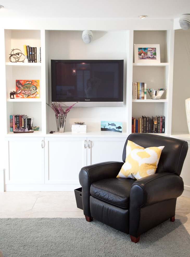 This is an example of a contemporary open concept living room in Tampa with a built-in media wall and white walls.