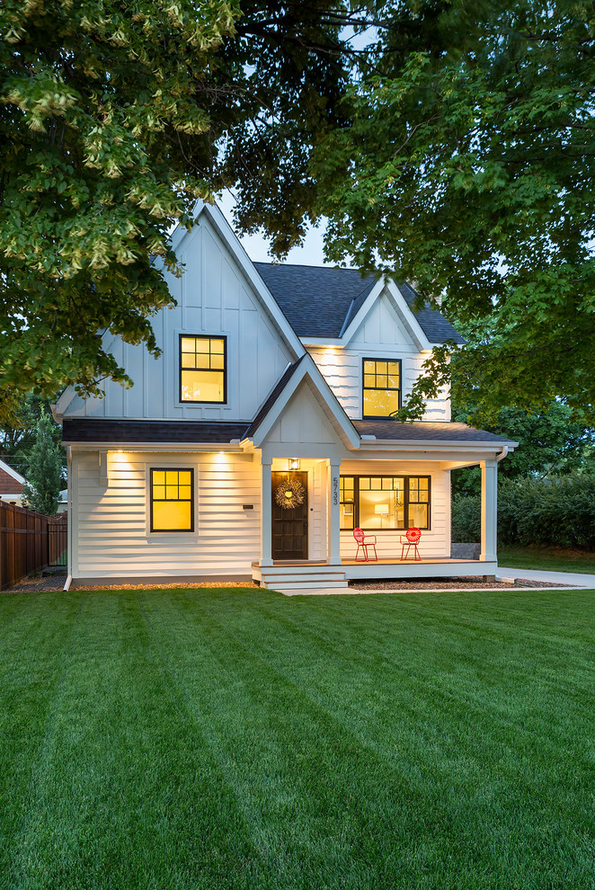 Photo of a mid-sized transitional two-storey white house exterior in Minneapolis with concrete fiberboard siding, a gable roof and a shingle roof.