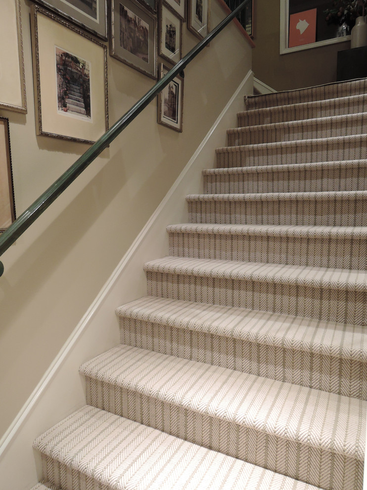 This is an example of a large beach style carpeted l-shaped staircase in Los Angeles with carpet risers.