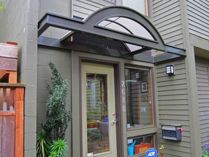 Design ideas for a small modern front yard patio in Portland with an awning.