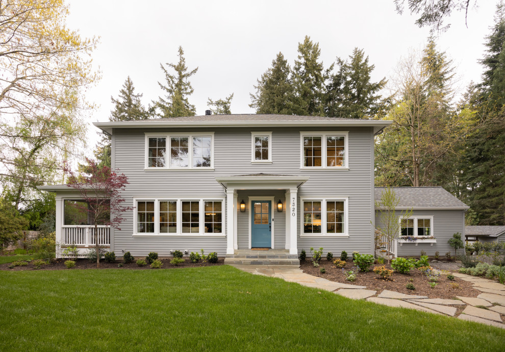 Large elegant gray two-story house exterior photo in Portland with a shed roof, a shingle roof and a gray roof