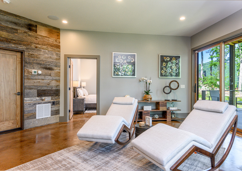 Example of a mid-sized mountain style concrete floor and brown floor basement design with green walls