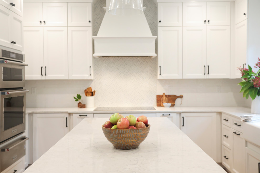 Transitional kitchen photo in Boston with white backsplash