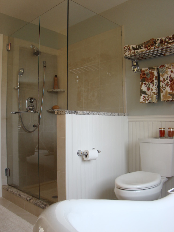 This is an example of a mid-sized traditional master bathroom in Portland Maine with an undermount sink, recessed-panel cabinets, white cabinets, granite benchtops, a freestanding tub, an alcove shower, a two-piece toilet, beige tile, ceramic tile, green walls and ceramic floors.