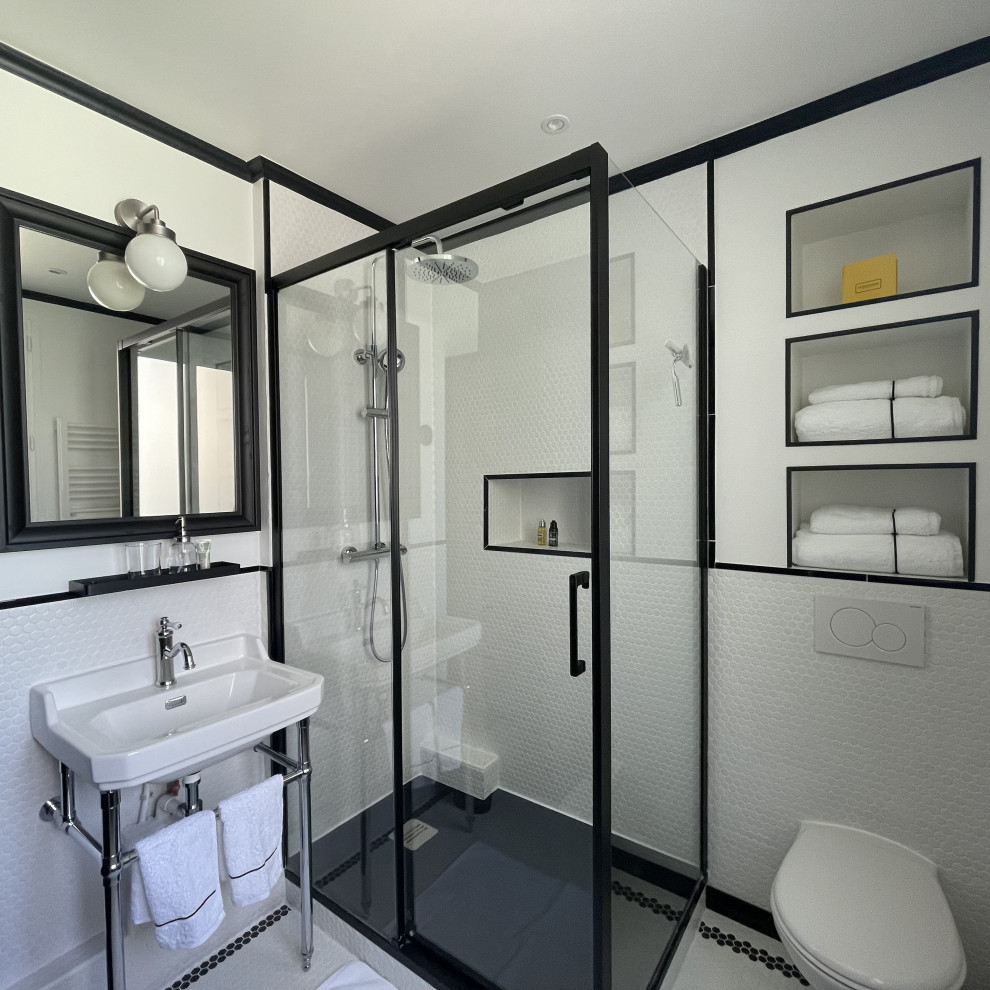 Design ideas for a small transitional 3/4 bathroom in Paris with black cabinets, a wall-mount toilet, white tile, mosaic tile, white walls, mosaic tile floors, a pedestal sink, black floor, a sliding shower screen, white benchtops, a niche, a single vanity and a freestanding vanity.