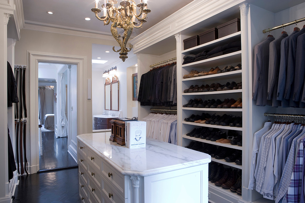 Design ideas for a traditional men's dressing room in New York with open cabinets, white cabinets and dark hardwood floors.