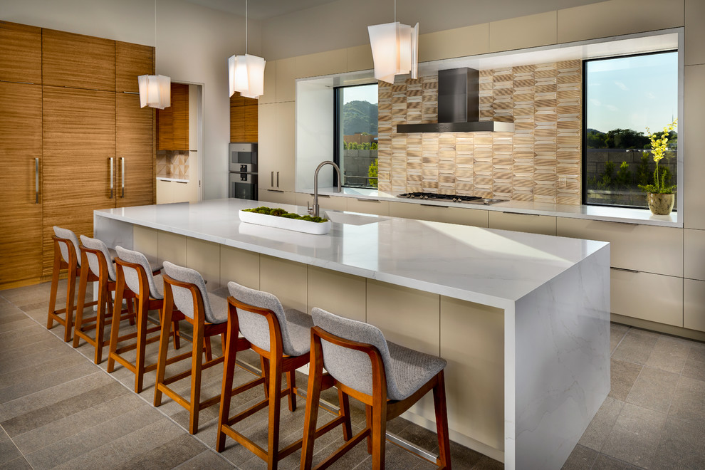 Photo of a large contemporary kitchen in Phoenix with flat-panel cabinets, quartz benchtops, beige splashback, ceramic splashback, porcelain floors, with island, grey floor, white benchtop, a single-bowl sink, beige cabinets and panelled appliances.