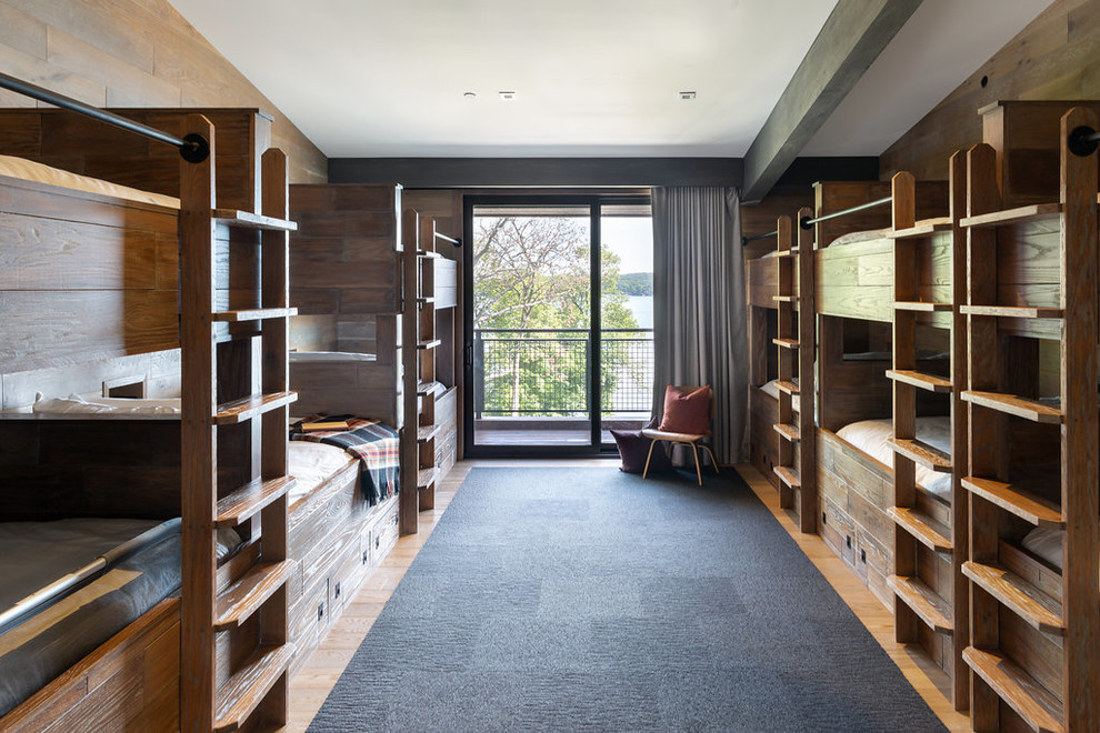 Photo of a contemporary gender-neutral kids' room in Chicago with medium hardwood floors and brown floor.