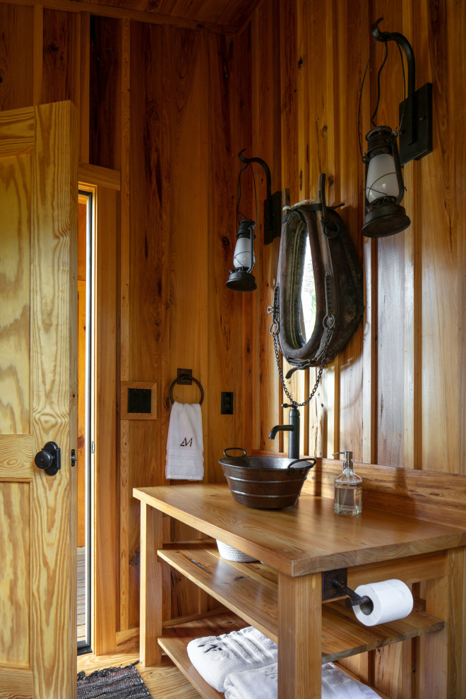 This is an example of a medium sized rural shower room bathroom in Tampa with open cabinets, light wood cabinets, a walk-in shower, a one-piece toilet, light hardwood flooring, a vessel sink, wooden worktops, an open shower, a shower bench, a single sink, a freestanding vanity unit and a wood ceiling.