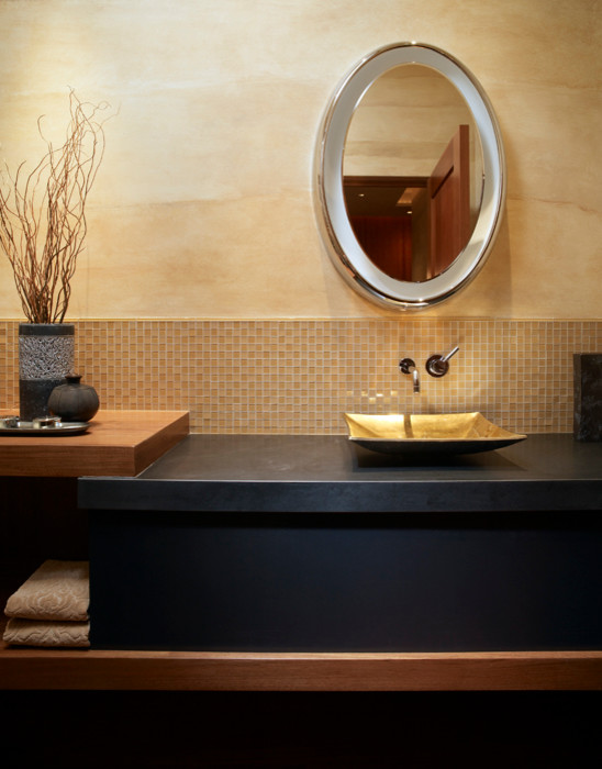 Photo of a mid-sized contemporary powder room in Other with black cabinets, beige tile, mosaic tile, beige walls, a vessel sink, soapstone benchtops and black benchtops.