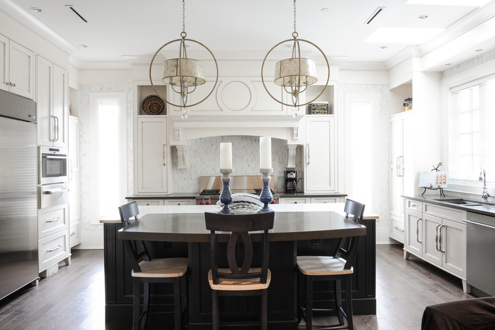 Inspiration for a transitional kitchen in Vancouver with a double-bowl sink, shaker cabinets, white cabinets, multi-coloured splashback, mosaic tile splashback, stainless steel appliances, dark hardwood floors and with island.