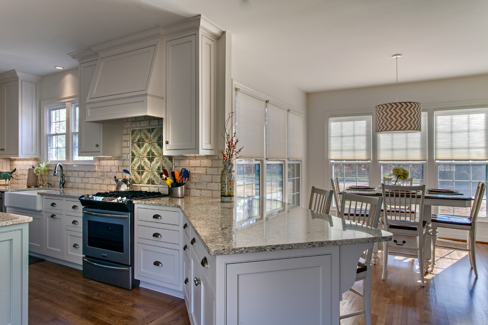 Design ideas for a country l-shaped kitchen in Nashville with a farmhouse sink, shaker cabinets, white cabinets, quartzite benchtops, white splashback, stainless steel appliances, medium hardwood floors and with island.